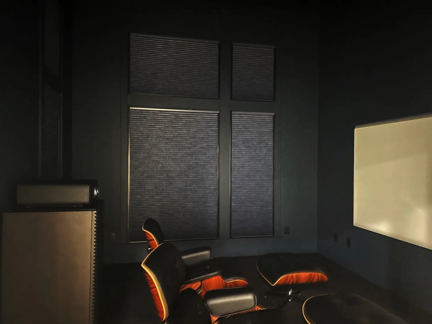 Motorized Duette Architella honeycomb shades with LightLock in an Issaquah media room