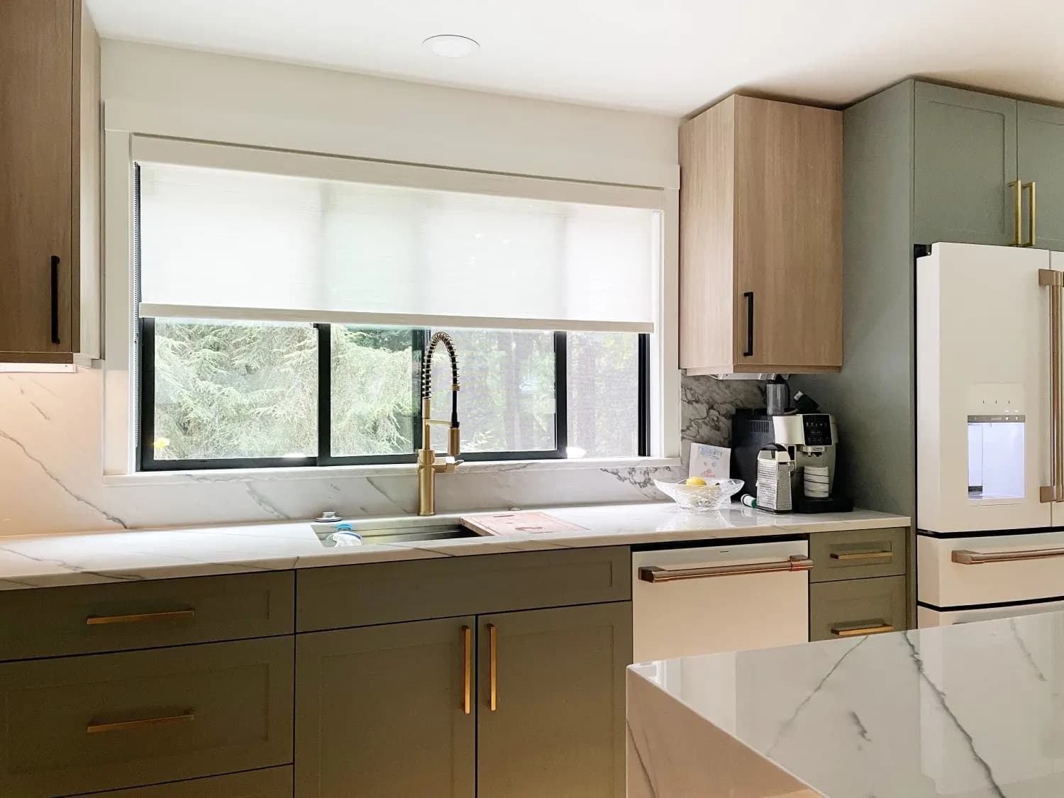 Roller shades installed on kitchen windows for easy cleaning