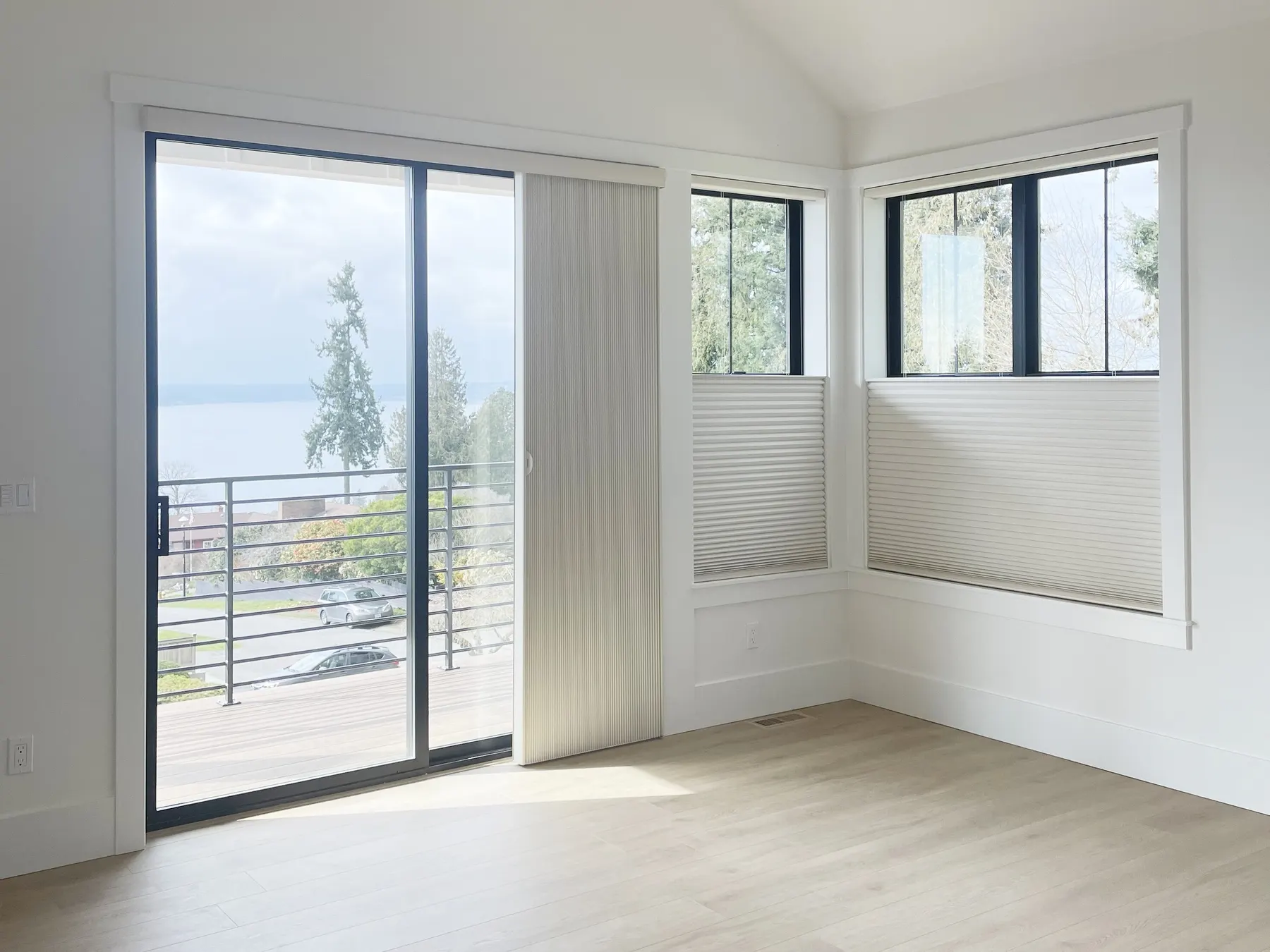 Vertiglide blackout honeycomb shade covering a sliding door in a Shoreline primary bedroom