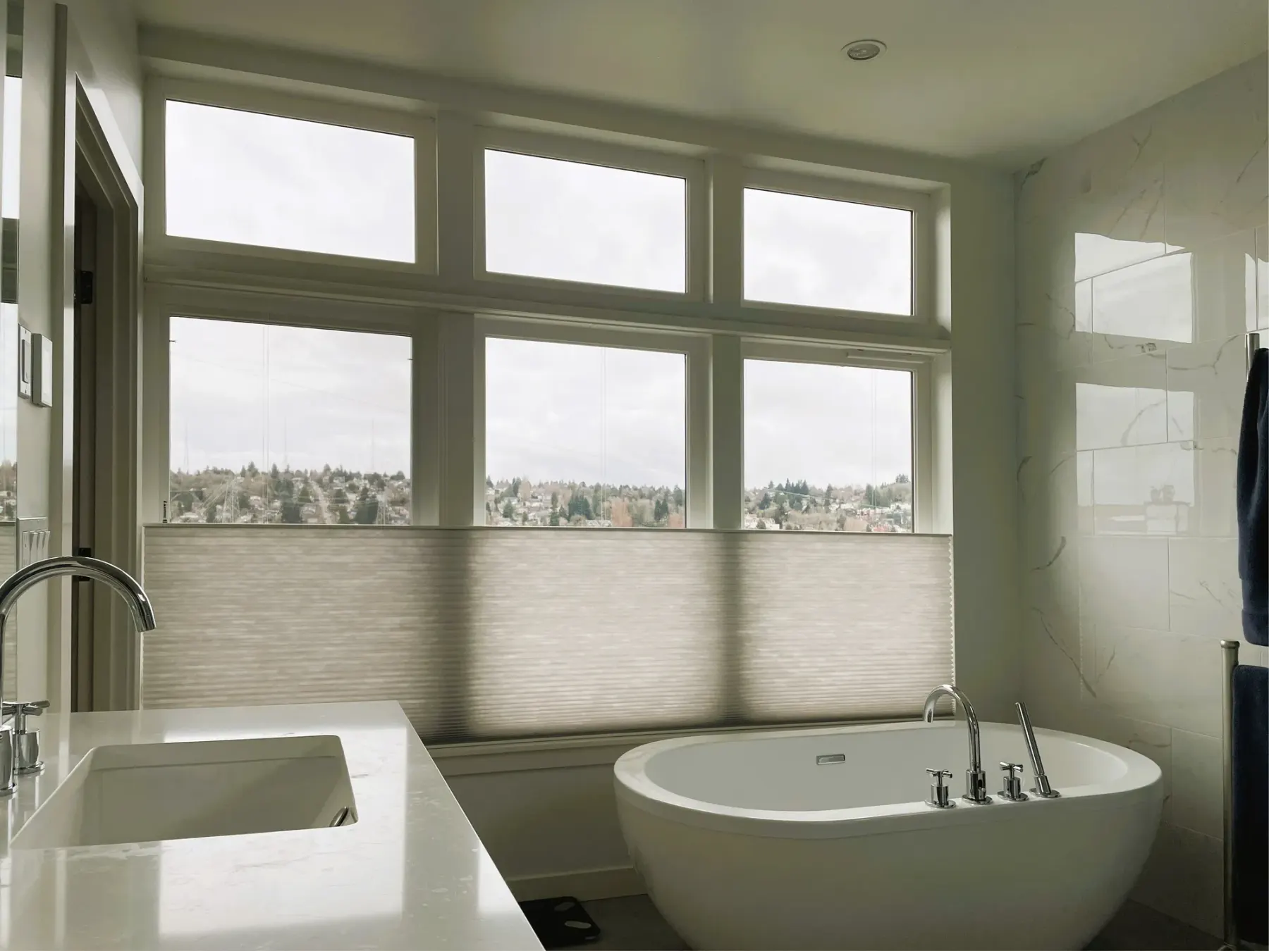 Motorized honeycomb shades with top-down/bottom-up functionality in a Seattle master bathroom