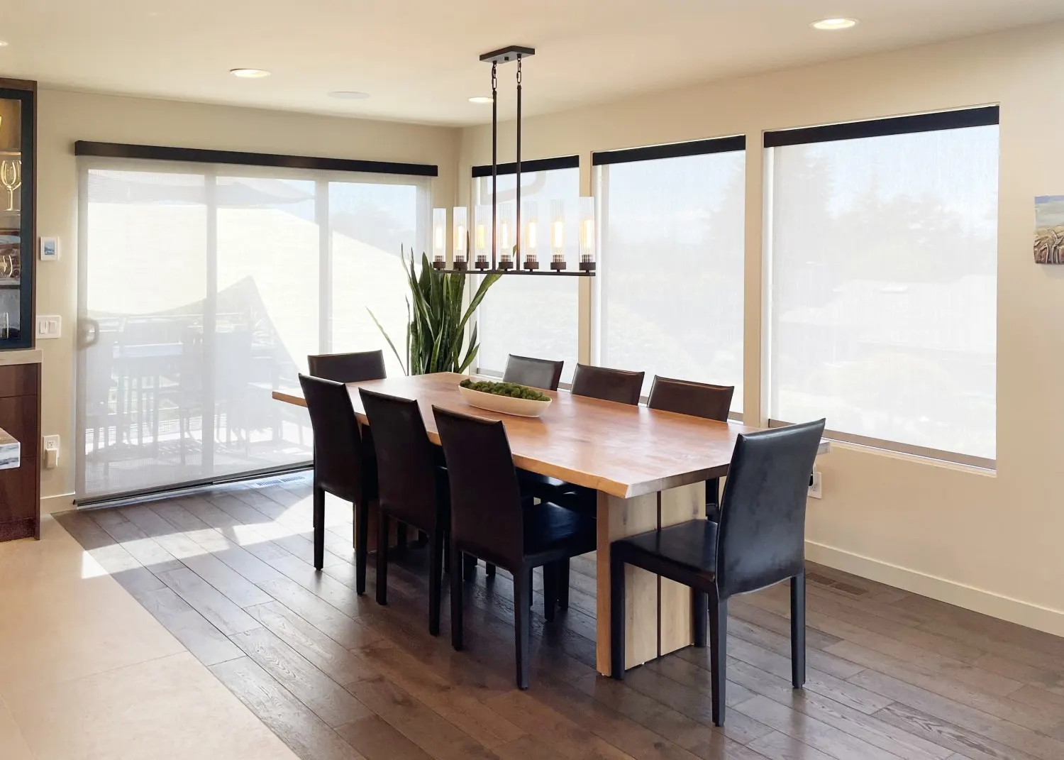 Motorized solar shades raised for dining room sliding glass door in Bellevue