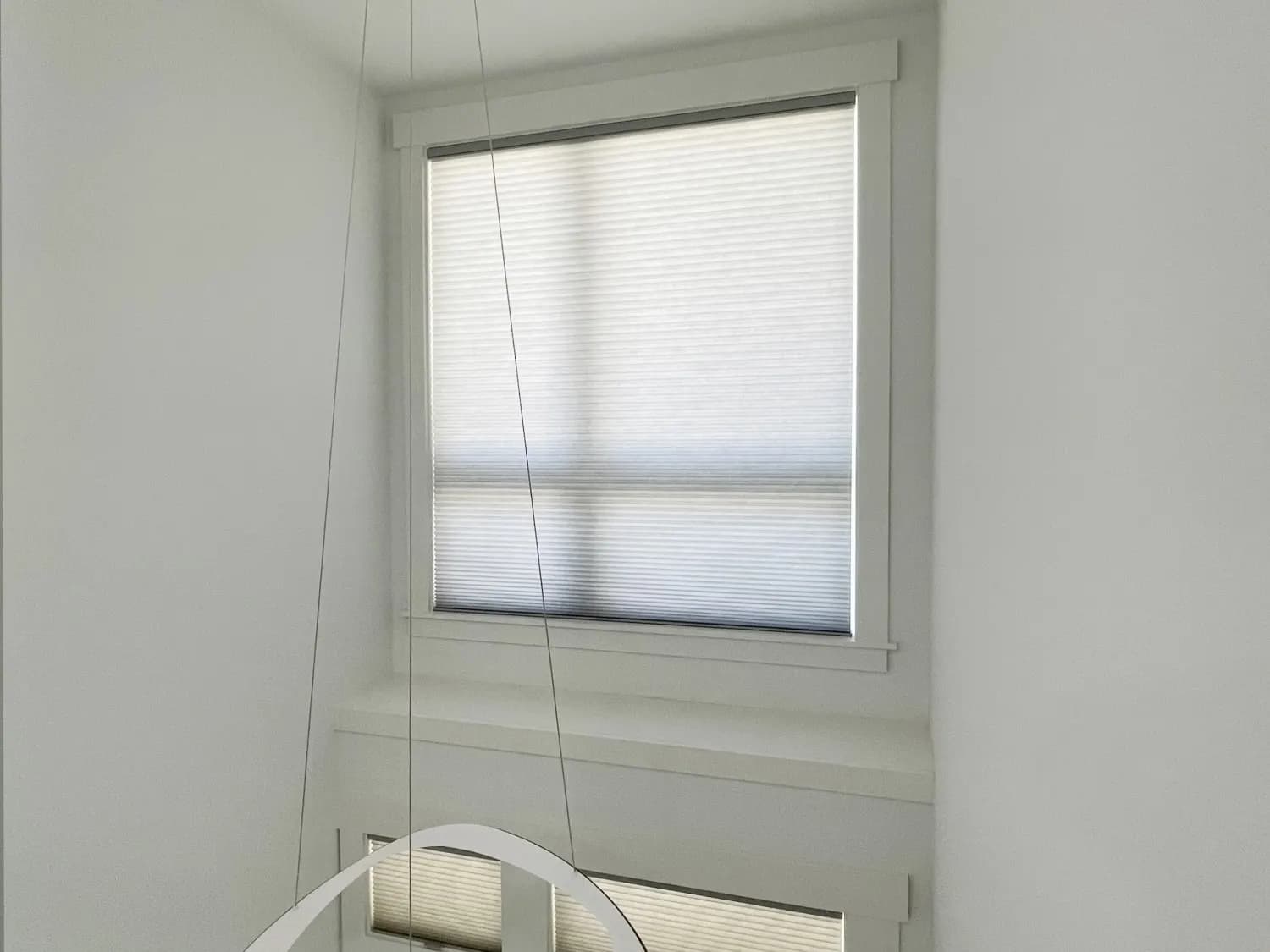 Motorized Duette honeycomb shades on upper entry windows in an Issaquah home