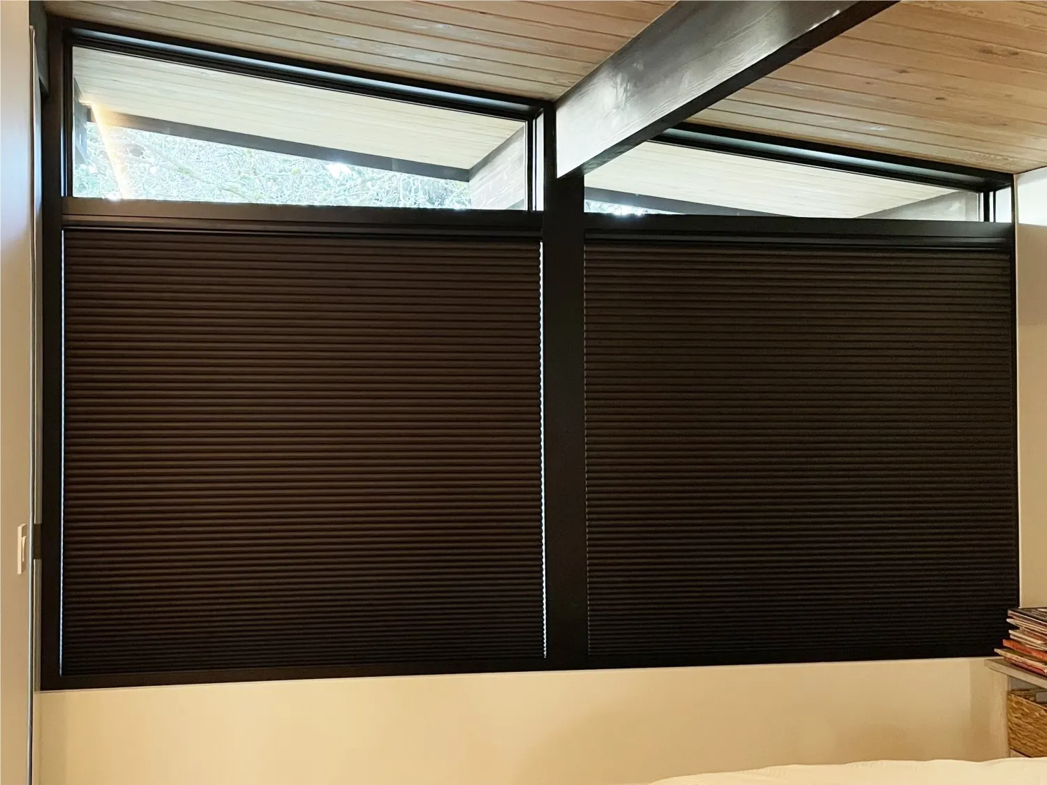 Black motorized honeycomb blackout shades coordinating with a remodeled primary bedroom in Mercer Island