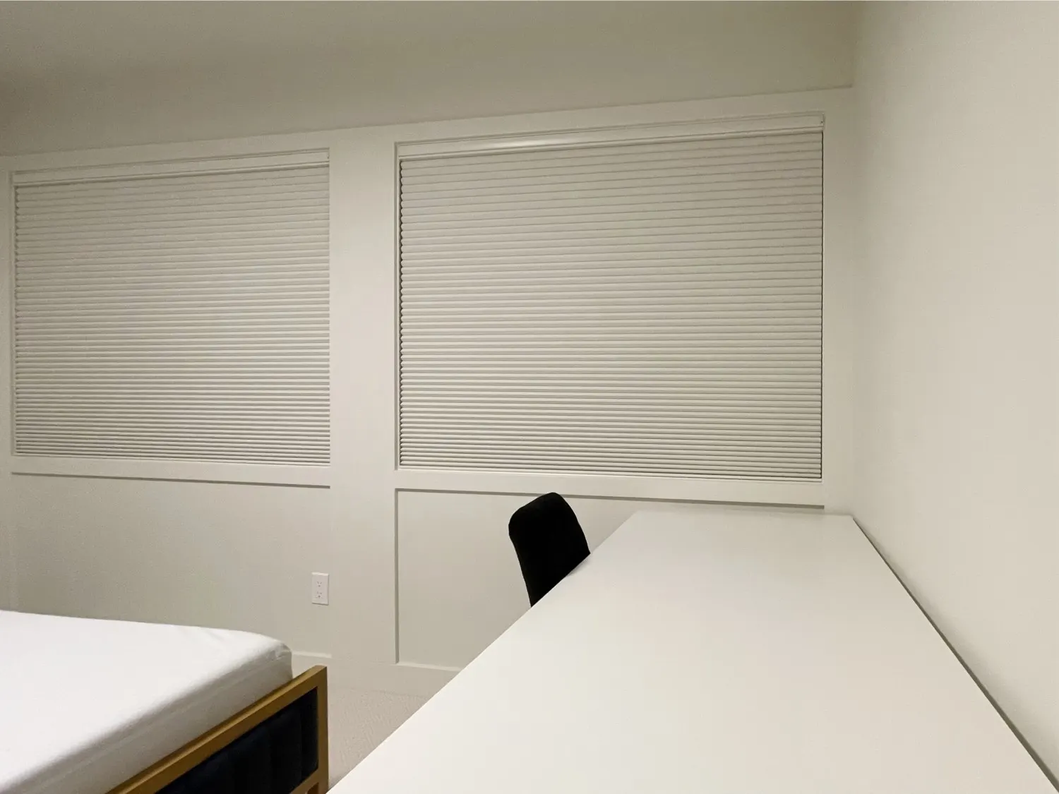 White motorized honeycomb blackout shades in a Mercer Island guest bedroom
