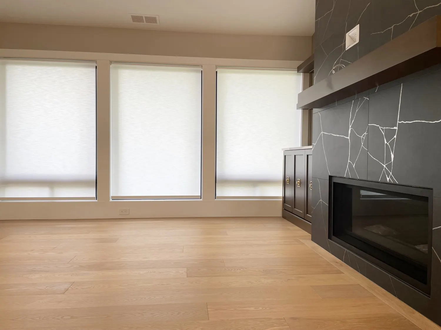 Motorized roller shades lowered for light control in a remodeled Redmond living room