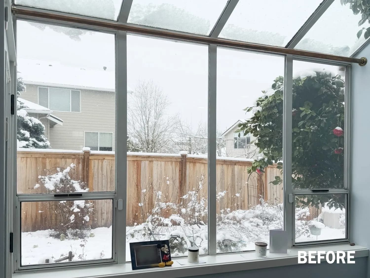 Wide uncovered solarium window in a Sammamish nook before motorized solar shades were installed