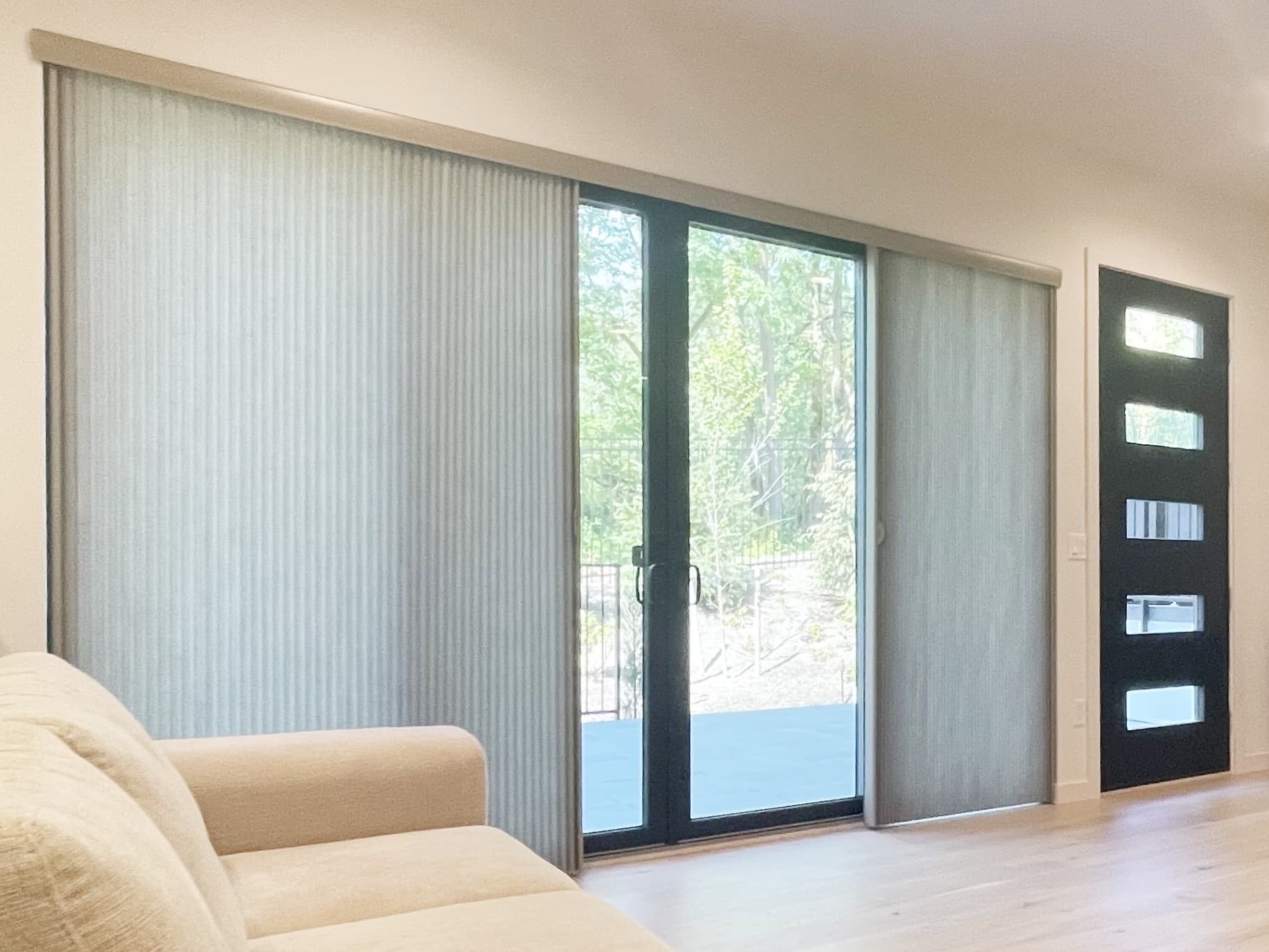Architella Vertiglide honeycomb shades on a sliding glass door in a Bellevue living room