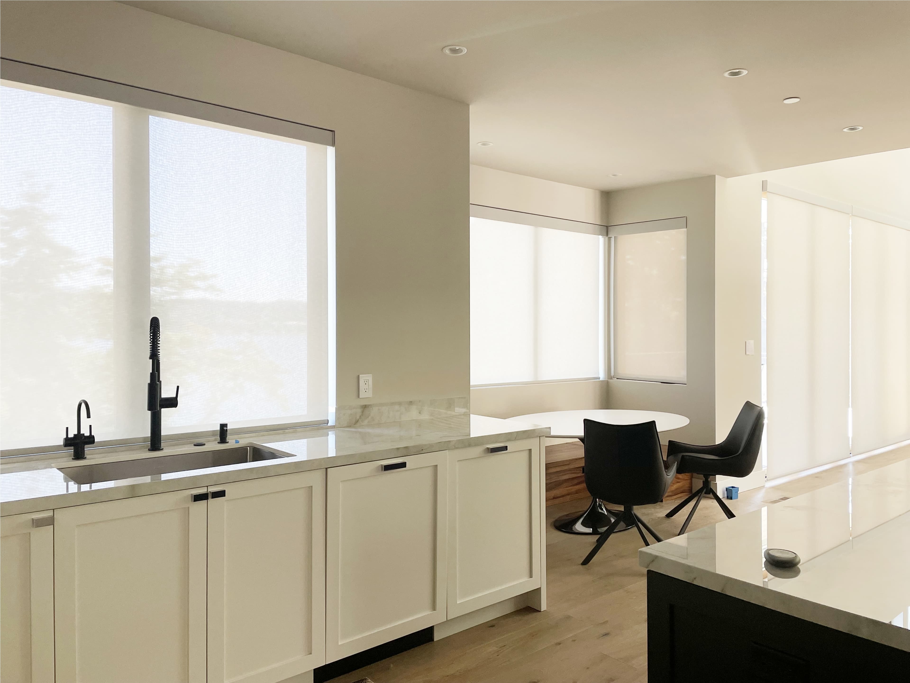 Motorized solar shades installed in a Mercer Island kitchen and breakfast nook