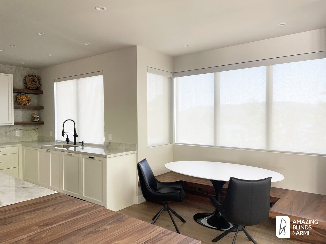 Motorized solar shades installed in a Mercer Island home to reduce glare and protect interiors from UV damage while preserving view.